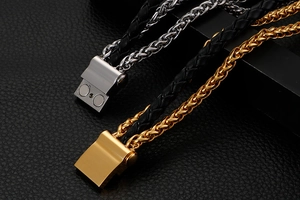 Detail of multi-layer black leather braid and metal dragon bone chain with magnetic clasp