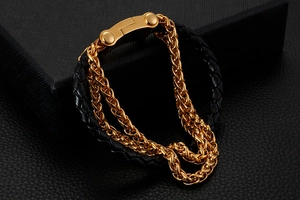Macro shot of men's leather braided bracelet with gold stainless steel chain details