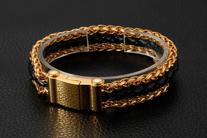 Detail of black woven leather men's bracelet with gold stainless steel chain and magnetic clasp
