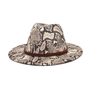 Detailed view of fedora hat with snakeskin pattern and brown braided leather strap