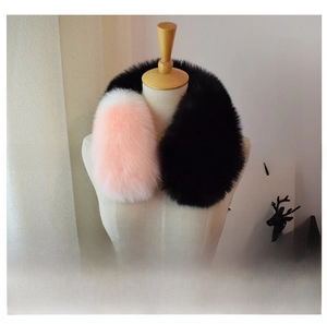 Detail of plush tricolor faux fox fur scarf in black, white, and pink color block