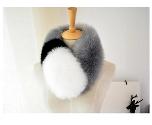 Detail view of the thick faux fox fur scarf with tricolor gray black and white patchwork