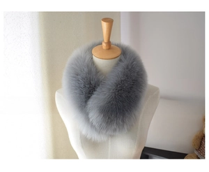 Close-up of a soft smoky gray faux fox fur scarf on a mannequin for winter warmth