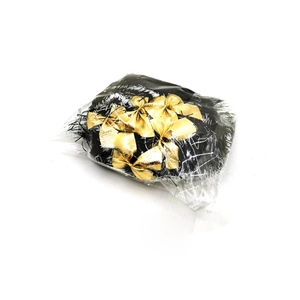Macro detail of 2m Christmas ribbon with bows and white edges in plastic packaging