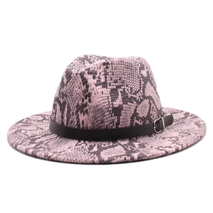 Detail of pink snakeskin fedora hat with wide brim, black leather band, and silver buckle