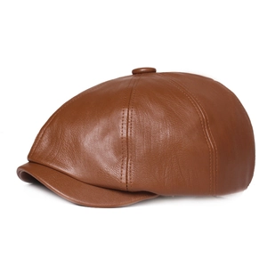 Detail of brown faux leather beret featuring vintage texture and precise side stitching