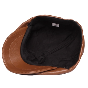 Brown leather flat cap with detailed interior lining and quality stitching textures