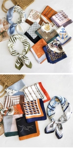 Detailed view of various printed silk scarves with vintage patterns and elegant designs