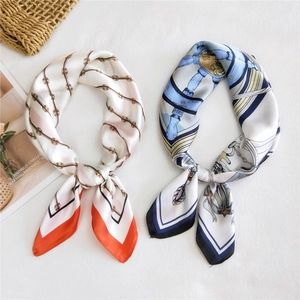 Elegant silk scarves with nautical chain and anchor prints on textured white fabric