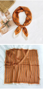 Detailed pattern of vintage square silk scarf with horsebit chain print and satin finish