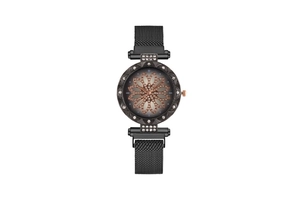 Close-up of women's black mesh watch featuring rose gold flower dial and crystals