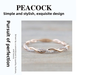 Macro detail of rose gold twisted rope ring with inlaid pavé cubic zirconia accents