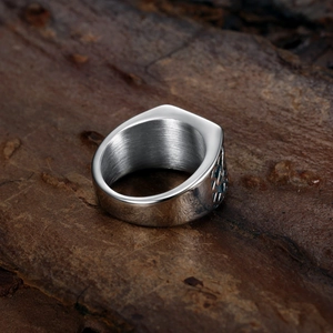 Vintage Irish Claddagh ring in silver stainless steel on natural wood background