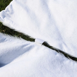 Detail view of the plush white faux fur Christmas tree skirt with Velcro closure fastener