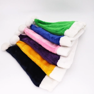 Group of colorful velvet Christmas hats in green, pink, purple, and blue colors
