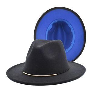 Detail of wool fedora hat featuring black exterior with royal blue contrast brim and gold trim