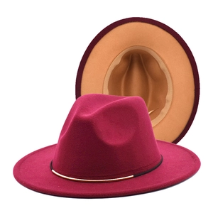 Detail of burgundy wool fedora featuring dual-color design and golden metal buckle band