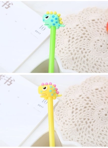 Close-up of cute green and yellow dinosaur pens showing soft silicone textures and details