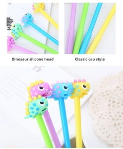 Detail view of colorful 3D silicone dinosaur toppers and cap-off design of these cute pens
