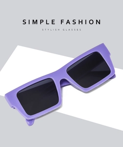 Macro shot of stylish purple rectangular sunglasses with dark lenses on geometric base