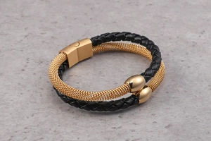 Detail of double-layer black leather braided bracelet with gold magnetic steel clasp