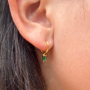 Elegant gold hoop earrings with rectangular emerald green gemstone drop charms