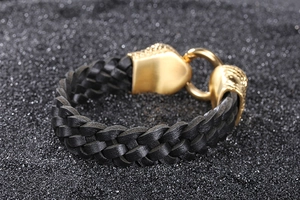 Close-up of black braided leather bracelet with a gold-toned metal magnetic clasp