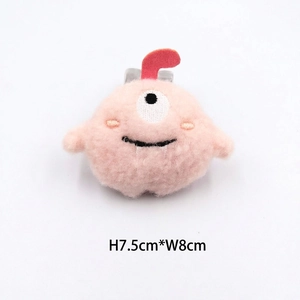 Detail showing the dimensions 7.5cm by 8cm of the pink plush monster brooch accessory
