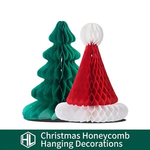 Christmas honeycomb paper ornaments featuring green tree and red Santa hat decorations