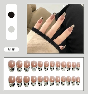 Detail of French cow print press-on nails in long ballerina shape with pink gradient