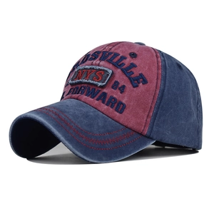 Detail of embroidered NYS logo on washed cotton baseball cap with red stitching