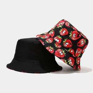 Detail of canvas bucket hats featuring black solid color and cute cartoon strawberry prints