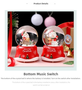 Detail of Christmas crystal ball music box set with Merry Christmas text and festive decor