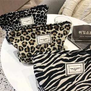 Detailed close-up of animal print canvas bags featuring leopard, zebra, and giraffe patterns