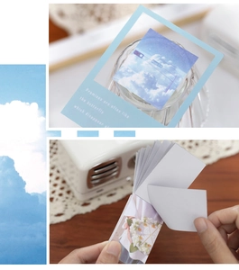Detail of sky-themed sticker book with blue cloud patterns and decorative paper pages