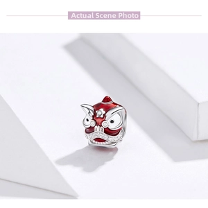 Close-up of S925 sterling silver Chinese lion dance charm with red enamel and zircon stones