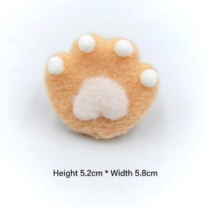 Detail view of plush cat paw pin with measurements of 5.2cm height and 5.8cm width