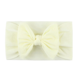 Soft cream yellow baby headband featuring a large nylon fabric bow accessory
