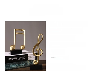 Modern gold resin music note figurines on black bases for stylish desk decor