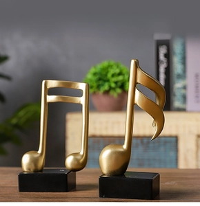 Artistic gold resin music note sculpture with matte finish and black square base detail