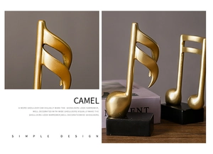 Close-up of golden music note resin sculptures with polished finish and black square bases