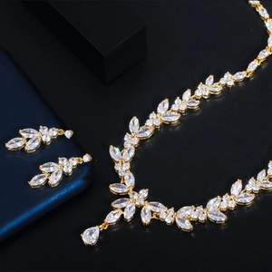 Macro shot of sparkling AAA zirconia leaves necklace and earrings set on dark background