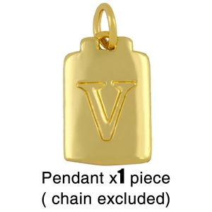 Detailed close-up of golden dog tag pendant with engraved letter V on white background