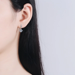 Elegant 925 sterling silver drop earrings featuring a 1 carat round moissanite stone