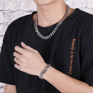 Silver stainless steel Cuban link necklace and bracelet set for men on model