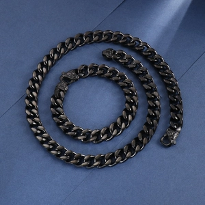 Macro shot of black curb chain jewelry set with detailed vintage relief clasps