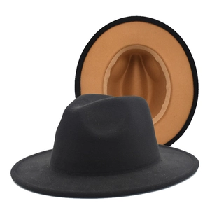 Detail view of two-tone wide brim fedora hat showing black exterior and camel interior