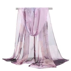 Detail of sheer georgette scarf with purple and grey floral pattern for beach sun protection