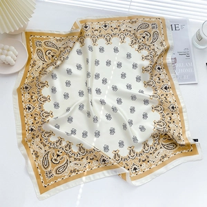 Macro shot of paisley silk scarf texture with golden pattern and soft window lighting