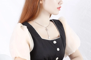 Detail of silver letter Z necklace pendant with chain drop on female model neck
